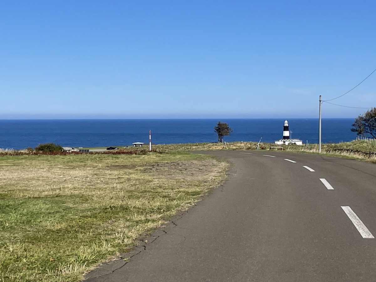 どこまでも広がる青空と水平線、緑豊かな草原が美しい夏の能取岬の景観
A wide panoramic view of the clear blue sky, deep blue ocean, and green grassland at Cape Notoro in summer